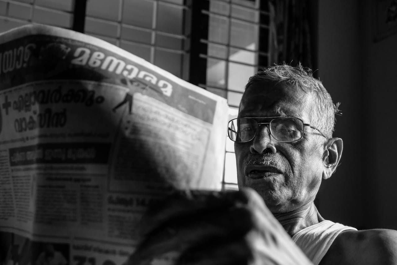 elderly man reading newspaper 10697640