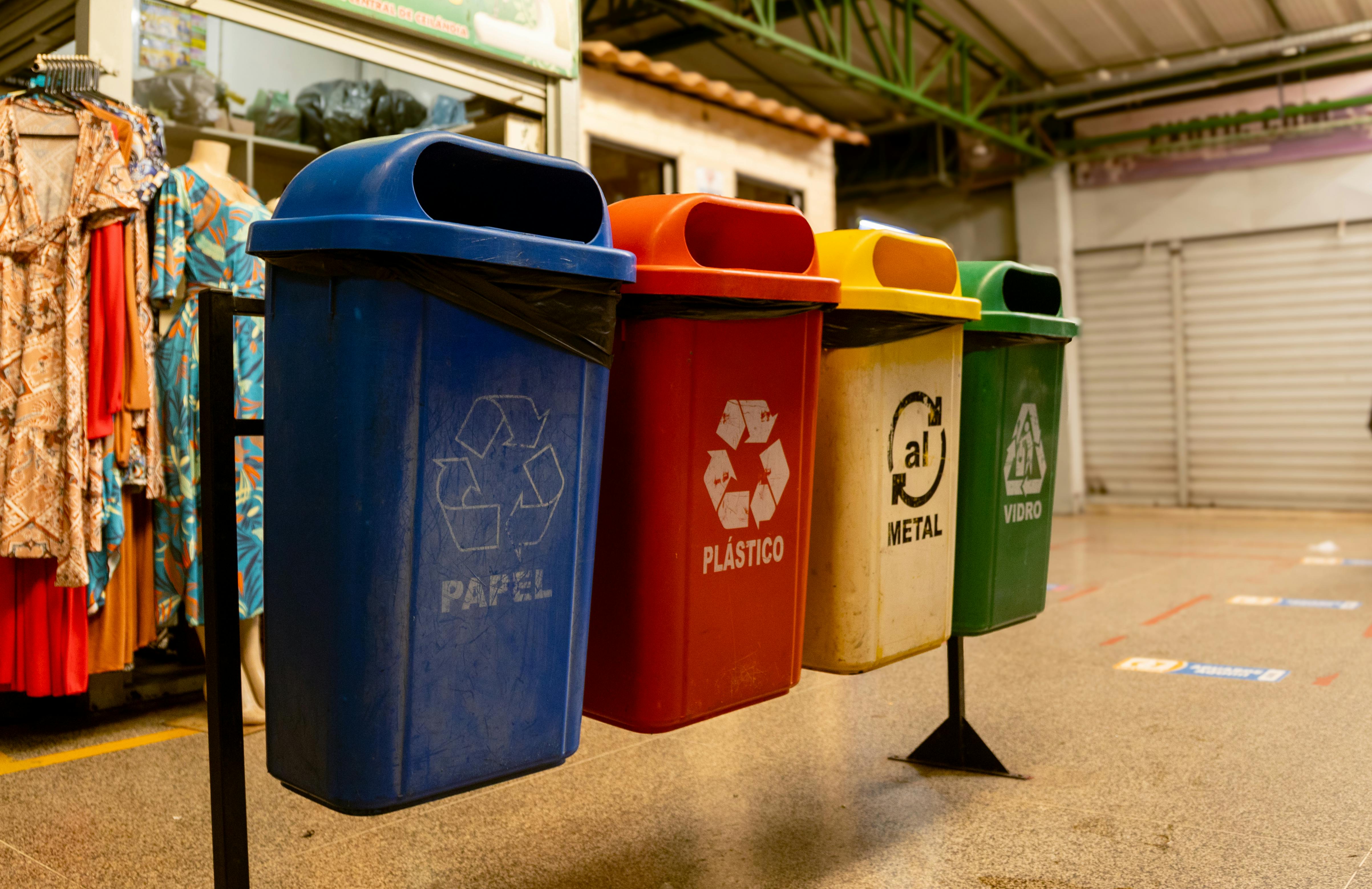 Project Categories Four recycling bins for paper, plastic, metal, and glass indoors.
